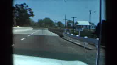 California USA (1969): Vehicle Driving Down The Highway And Crossing A Bridge