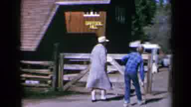 California USA (1969): Injured Boy Limps His Way Up Daffodil Hill With A Companion