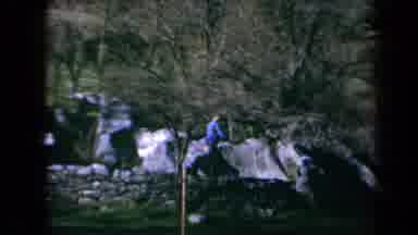 California USA (1969): Child Jumping Off A Rock And Does A Flip