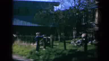 California USA (1969): Panover Of Young Boy Leaning On Fence While Looking At Old