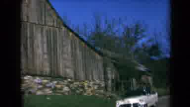 California USA (1969): Car Driving Past Barn