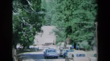 California USA (1969): Traffic Jam On Small Rural Area Near Building In A Town