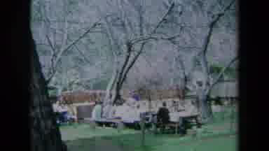 California USA (1969): Group Of Adults And Children Having A Picnic At Tables