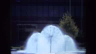 California USA (1969): Three Spewing Water Fountains In A Park In Front Of A