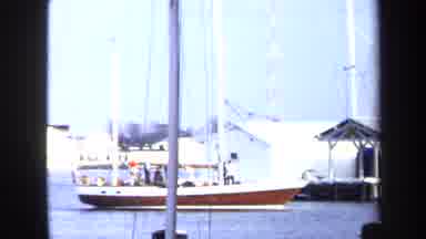 Annapolis USA (1970): Sailboat Enters The Harbor On A Cloudy Day