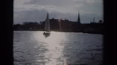 Annapolis USA (1970): Sailboat In A Body Of Water And A Jet Plane On Display