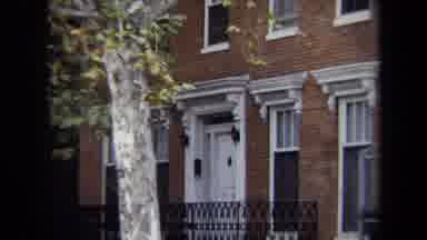 Annapolis USA (1970): White Door Against Brick Building Showing Black Fence And
