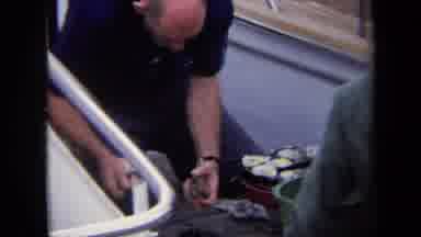 Annapolis USA (1970): 2 Men Are On The Boat While One Of Them Are Standing Outside