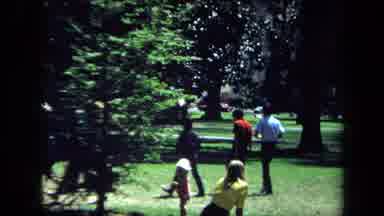 California USA (1970): Large Group Of Young People Quickly Walking Thru A Park