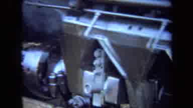 California USA (1970): A Steam Train Engineer Walking Down Of The Side Of The