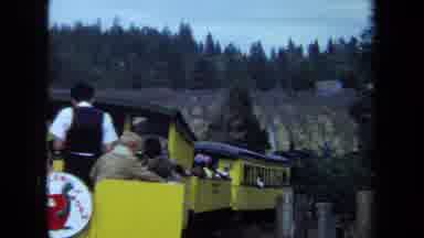 California USA (1970): Coal Train Loaded With Passengers Being Shown The Landscape