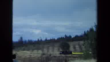 California USA (1970): A Man Watches As A Train Passes Through Open Field
