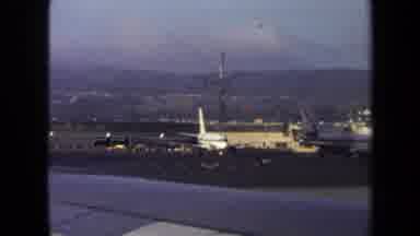 Washington DC USA (1970): Loaded Luggage Tram Moving Across Crowded Airport Runway