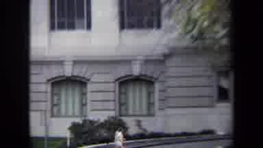WASHINGTON DC USA-1970: Fit Jogger Runs Past A Tall Old Grey Brick Building