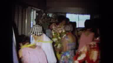 California USA (1971): Group Of People In A Room With Majority Wearing Flowered