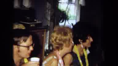 California USA (1971): Group Of People Sitting Enjoying Party Eating And Drinking