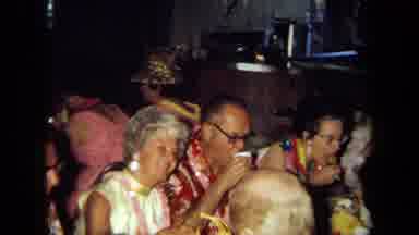 California USA (1971): People Sitting At A Table As Some Eat And Others Are Up