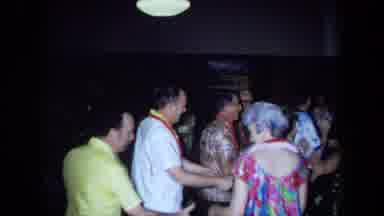 California USA (1971): Adult Couples Wearing Hawaiian Print Attire And Leis
