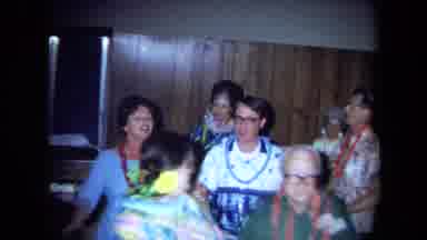 California USA (1971): Adult Couples Wearing Hawaiian Print Attire And Leis
