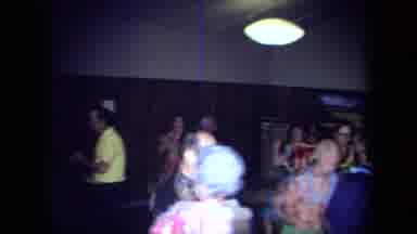 California USA (1971): Couples With Leis Dancing And Clapping At An Event Indoors