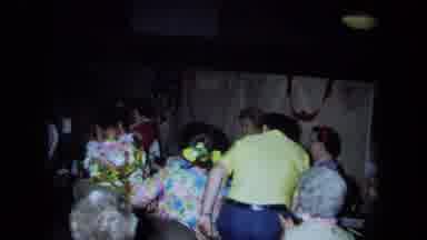 California USA (1971): People At Party With Attention To Older Lady Dancing