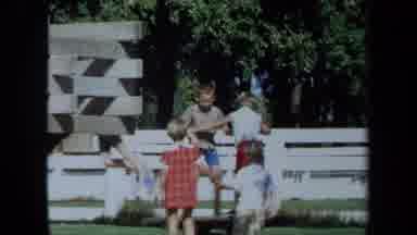 California USA (1971): A Group Of Kids Jumping On A Toy In A Park Right In Front