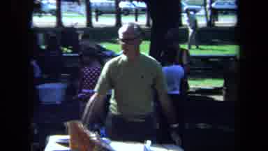 California USA (1971): A Guy In A Green Shirt Walking Around Smoking A Cigarette
