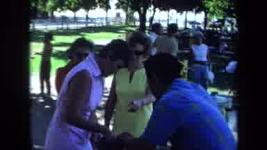 California USA (1971): Three People Outside Talking At Outdoor Campground In