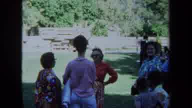 California USA (1971): 1960s Women Talking In A Park In Front Of Man Running