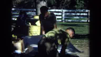 California USA (1971): Guys In Green Shirts Making A Table And Putting A Cloth On