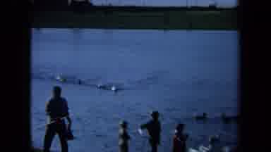 California USA (1971): Teen Males Walk Across An Athletic Field Followed By