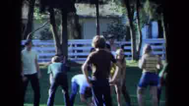 California USA (1971): A Group Of Several People Play Football At At Park