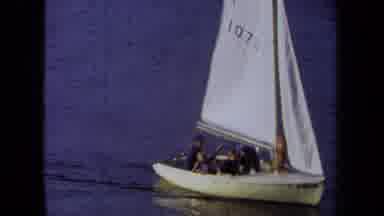 California USA (1971): A Group Of People Having Fun Talking And Sailing On A Small