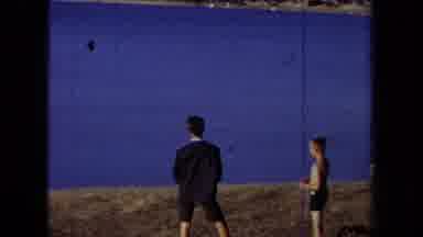 California USA (1971): Two Young Male Individuals Standing By A Body Of Water And