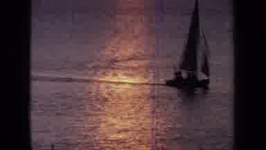 California USA (1971): Rotating Mask And Sailboat On Water At Dusk
