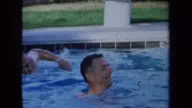 California USA (1971): Happy Men Swimming In A Community Pool On A Sunny Day