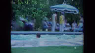 California USA (1971): A Guy Swimming In A Pool With Only His Head Sticking Out Of