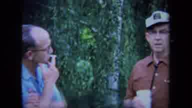 California USA (1971): Two Guys Smoking Cigarettes And A Sign Came Up That Says
