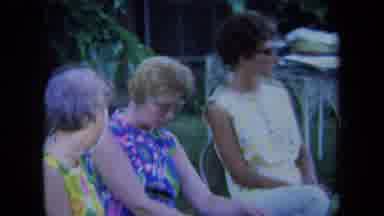 California USA (1971): Women Sitting In A Yard On Lawn Chairs Holding A