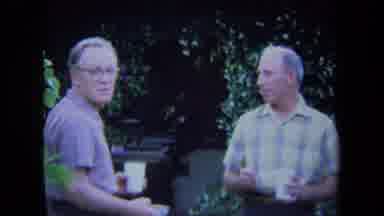 California USA (1971): Four Men Talking And Eating In A Backyard On A Sunny Day