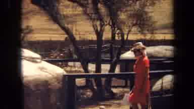 Laguna Hills California USA (1971): A Woman In An Orange Dress And A Hat Walking
