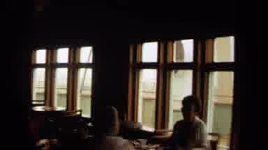 Long Beach California USA (1971): A Camera Pans Around A Building Looking Out Of
