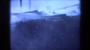 Maine USA (1971): Stacked Wooden Logs In Front Of Tall Masts