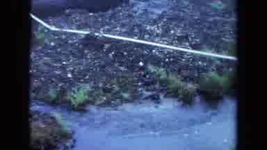 Maine USA (1971): River With Flowing Water And A Plastic Tube Indicating The Way
