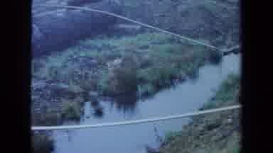 Maine USA (1971): Overhead View Of Several Pipes Crossing A Small Stream With