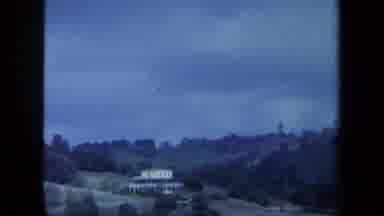 Maine USA (1971): A White House On A Hill Surrounded By Multiple Species Of Trees