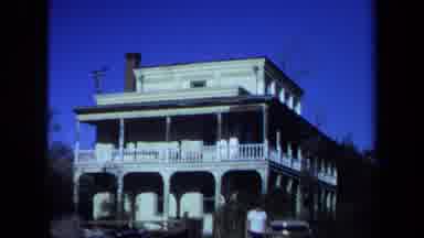 Maine USA (1971): Young Man Leaving Plantation Style Building With Archway