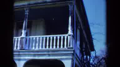 Maine USA (1971): Two-Story White Porch And Woman In White Shirt Walking Along The