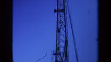 Maine USA (1971): Men Holding Ropes That Are Going Up Tool Giant Metal Tower