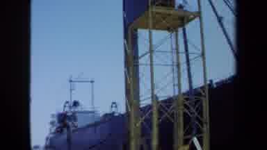 Maine USA (1971): Vertical Yellow Truss Structure And Large Pile Of Lumber On Top